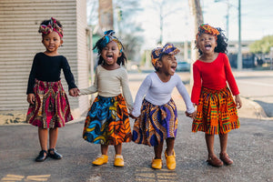 Little African American girls having fun in their African print skirts from Ackee Tree Clothing 