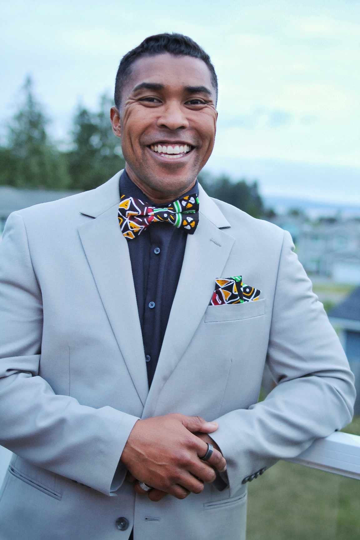 African American man wearing an Afrocentric print bow tie with matching pocket square