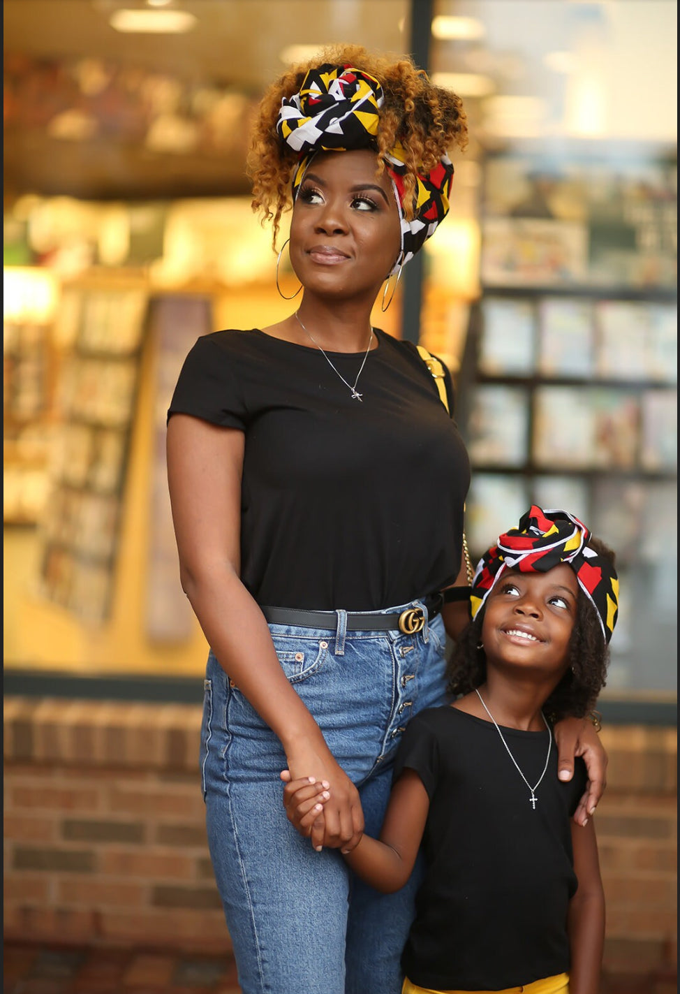 Red and black Angolan African print head wrap for mommy and child. An African American mommy and little girl is shown modeling the headwra