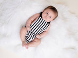 Baby in a black and white striped romper 