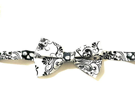 White skulls bow tie with a white purposely faded print. Skulls may fall anywhere on the bow tie. 