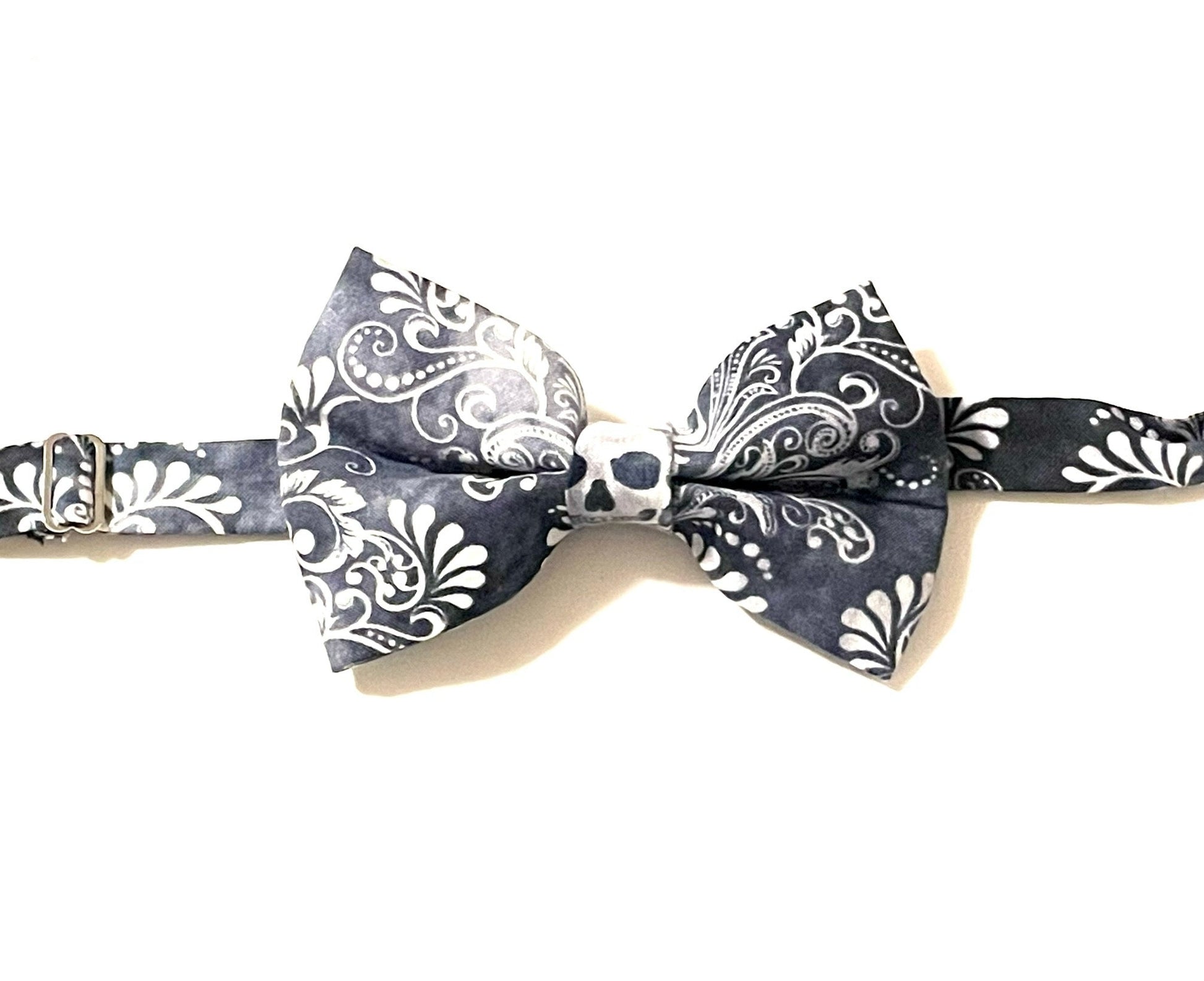 Black skulls bow tie with a purposely faded print. Skulls may fall anywhere on the bow tie