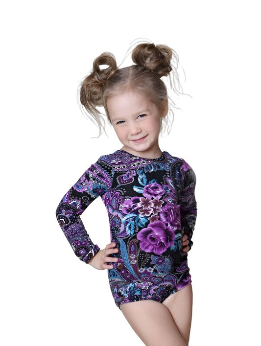 Little girl wearing a purple print leotard that comes in three different sleeve lengths. 