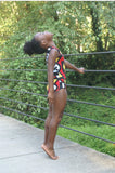 Black girl dancing and doing gymnastics in her African Print Leotard.