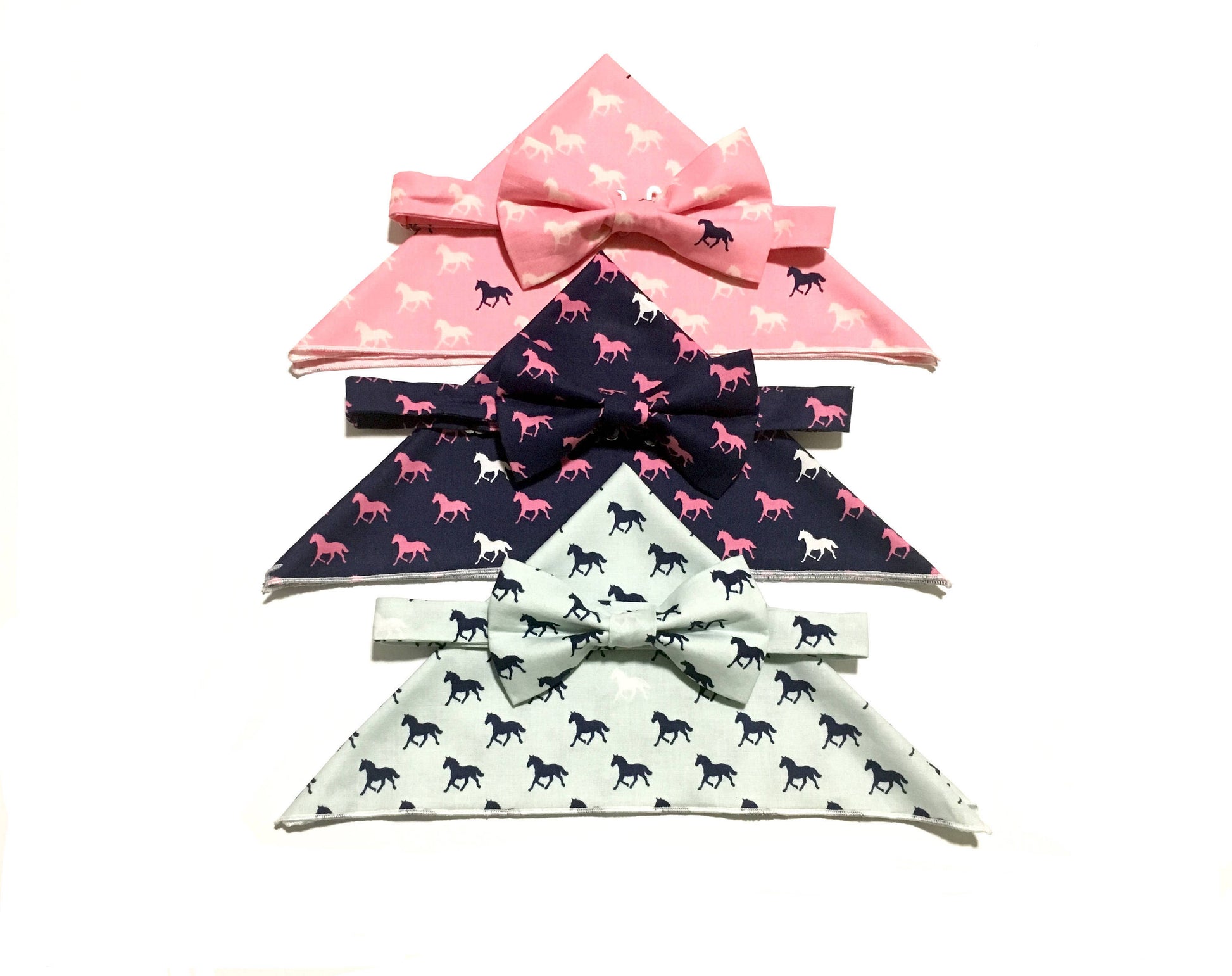 Men’s and boys derby horses print pre-tied bow ties with matching pocket squares in the colors aqua, pink and navy with different colored horses on the print.