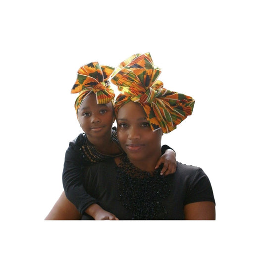 Kente African print head wrap for mommy and child. An African American mommy and little girl is shown modeling the headwraps. 