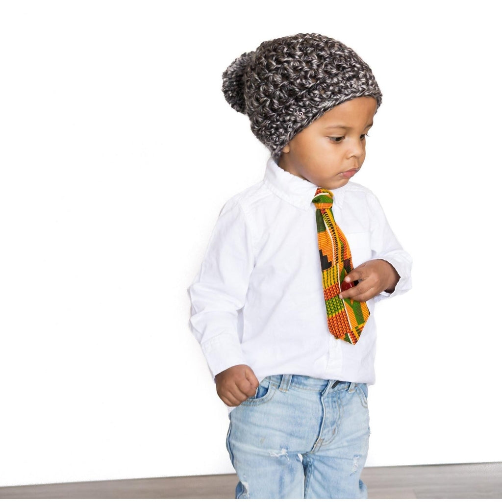 African American child about 4 years old wearing a kente tie with matching neckband which closes with hook and loop closure. 