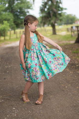 Girl wearing a mint floral summer sleeveless dress